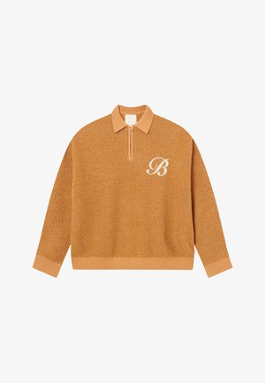Honey-colored knit pullover with a zip collar. Features ribbed cuffs and hem, textured fabric, and an embroidered white letter ‘B’ detail.