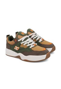 Green and brown sneakers with a mesh and suede upper, white laces, orange accents, and a rubber outsole. DC logo displayed on the side.
