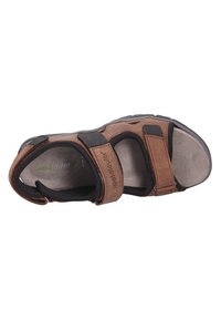 Brown leather sandal with two adjustable straps and a padded insole. Features a textured black rubber sole and branding on the side.
