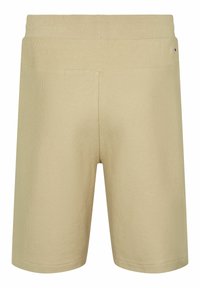Short en maille beige avec taille élastique côtelée et petite étiquette logo sur le dessus, tissu texturé, coupe jusqu'aux genoux.
