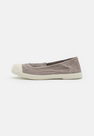 Gray canvas slip-on shoe with a rubber toe cap and white textured sole. Smooth upper with a slight sheen, minimal stitching details.
