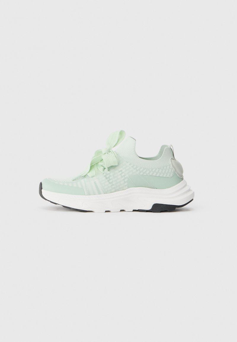 Light green athletic shoe with knitted upper, textured accents, and a padded collar. Features a thick white midsole and black outsole.