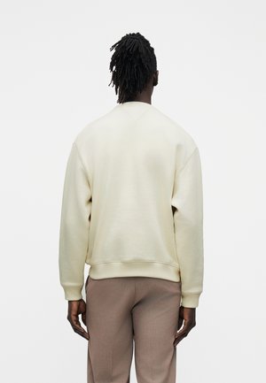 Tommy Hilfiger HERITAGE CREST EMBROIDERY RELAXED SWEATSHIRT - Bluză de molton - ivory petal