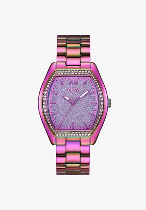 Heksagonalni ružičasti sat s kristalnim detaljima, metalnom narukvicom i teksturiranom brojčanicom. Ima karakteristične oznake sati i sjajnu površinu.