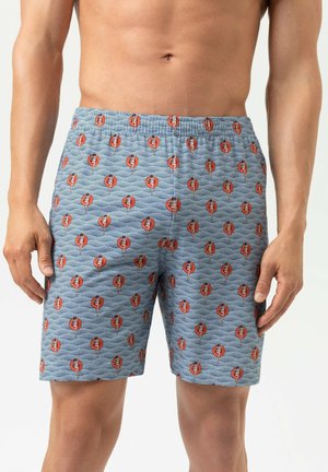 Blaue gemusterte Boxershorts mit Wellenmuster und roten/schwarzen grafischen Akzenten. Elastischer Bund sichtbar; Stoff wirkt weich und strukturiert.