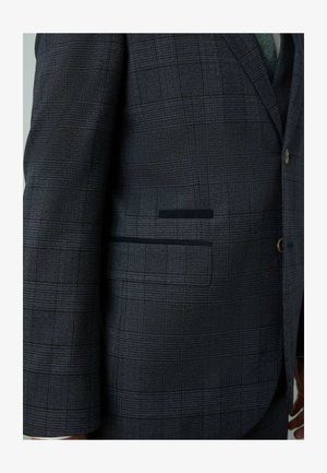 Dark plaid blazer with a textured fabric, featuring a notch lapel, button closure, and a single pocket with a contrasting dark accent.