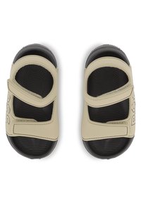 Ανοιχτό μπεζ σανδάλια με ρυθμιζόμενα λουριά, μαύρες αντιθετικές σόλες και υφή στην εσωτερική σόλα. Φέρουν το όνομα της μάρκας εμφανώς στο πλάι.