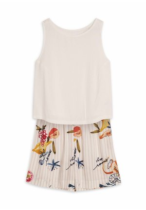 White sleeveless top with a soft texture and pleated floral shorts featuring yellow, red, and green patterns on a striped background.