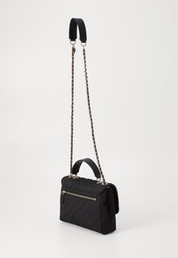 Black quilted handbag with dual straps: a chain strap and a soft handle, featuring a zip pocket on the front and sleek gold hardware accents.