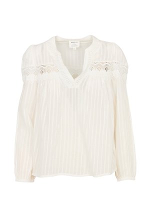 Camicia bianca ampia con scollo a V, con dettagli in pizzo trasparente sulle spalle, texture a righe e maniche lunghe a sbuffo.