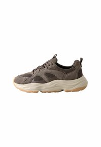 Brown suede and mesh sneaker features a thick cream midsole and gum rubber outsole, with rounded toe and lace-up design.