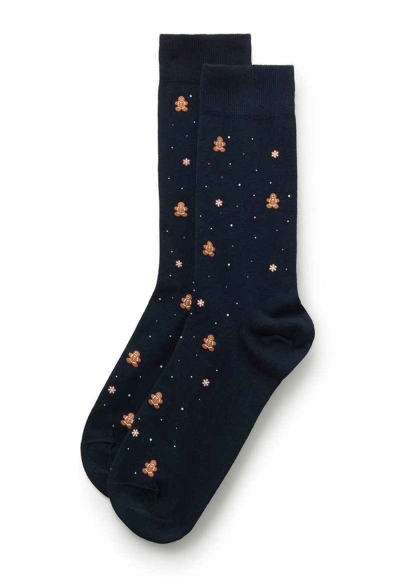 Mørkeblå sokker med designs af gingerbread-mænd og hvide snefnug, med en glat tekstur og ribbet kant.