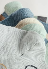 Lot de chaussettes en coton colorées. Caractéristiques de textures tricotées légères en vert clair, bleu, beige et gris avec diverses rayures horizontales et motifs.