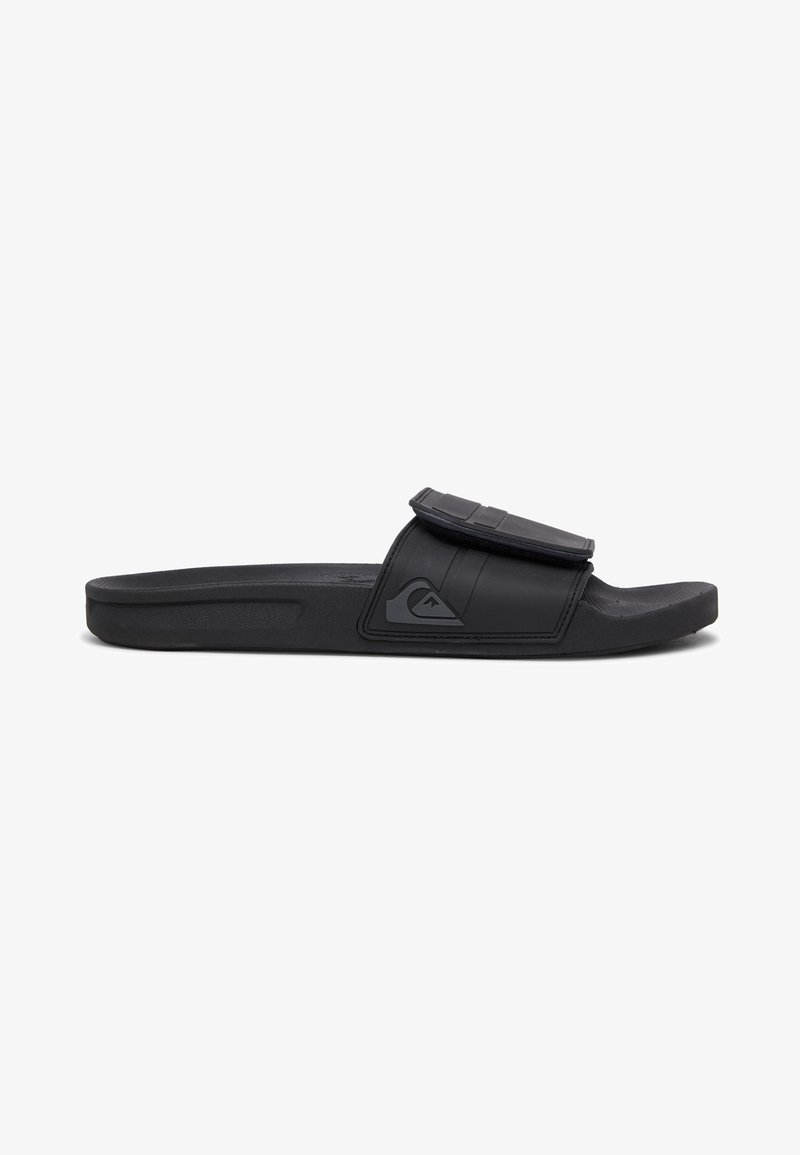 Black slide sandal made of rubber with a textured upper strap, featuring a logo on the side and a flat, contoured footbed.