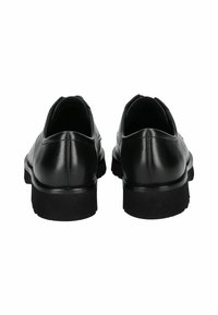 Chaussures en cuir noir avec une finition lisse, bout rond et une semelle en caoutchouc noir légèrement surélevée. Design minimaliste sans éléments décoratifs.