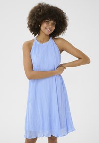 Light blue pleated dress with a halter neck design, flowing skirt, and smooth texture. Features delicate shoulder straps and a slightly scalloped hem.