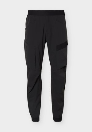 Pantalon cargo noir avec taille élastique, poches latérales et poignets élastiques, présenté sur un fond blanc uni.