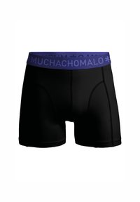 Black boxer shorts with a purple elastic waistband featuring the text "MUCHACHOMOLO." Smooth material with a fitted design and contrasting stitching.