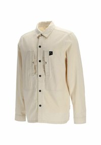 Camicia button-up beige chiaro con maniche lunghe, due tasche frontali, bottoni neri, una piccola etichetta con logo sulla tasca sinistra e colletto.