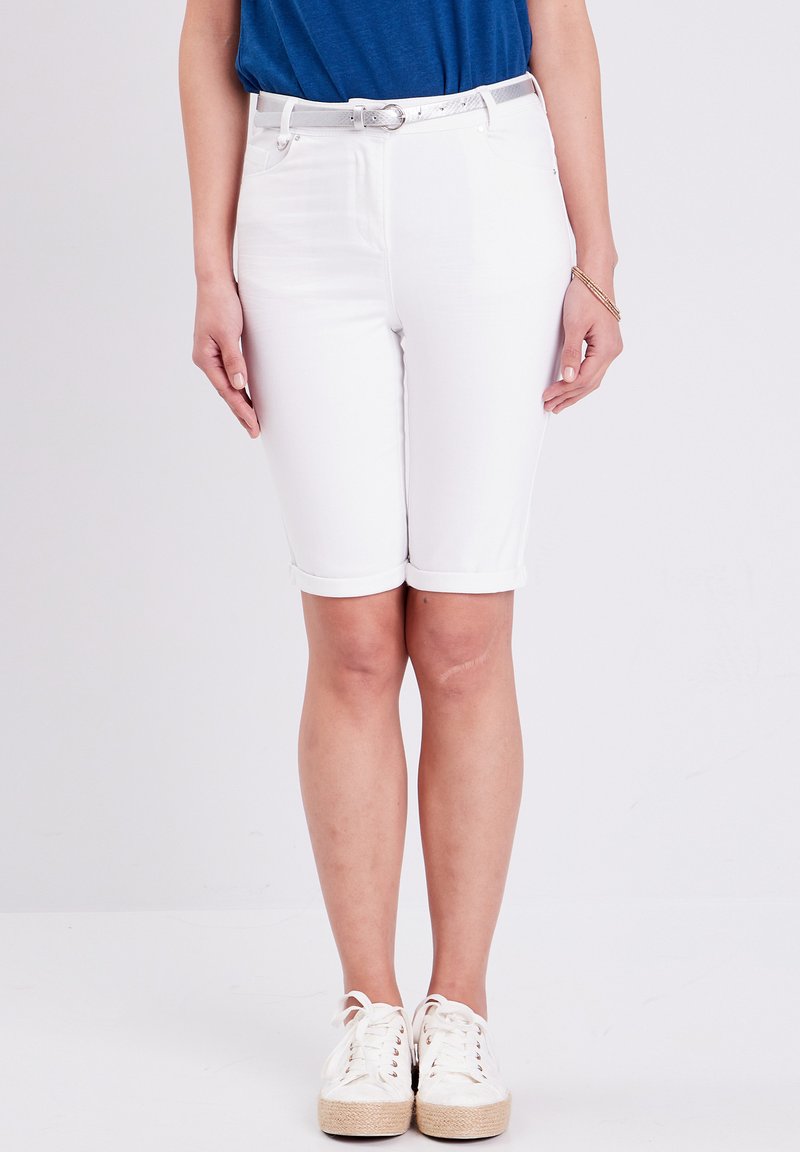 Bermuda short in denim bianco con risvoltini, caratterizzati da una vestibilità slim. Abbinati a un top blu e sneakers bianche con lacci. Include una cintura argentata.
