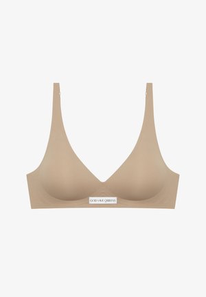 Beige wireless bra in a smooth fabric with a deep V-neck, wide straps, and a label reading "GOD SAVE QUEENS" at the center.