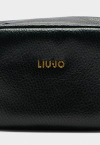 Borsa nera in pelle texturizzata con logo dorato "LIU·JO". La finitura è elegante, con un leggero motivo in rilievo sulla superficie.