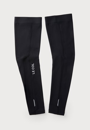 Black cycling leg warmers made from stretchable fabric. Features white "LE COL" logo and reflective accents. Fitted shape for comfort.