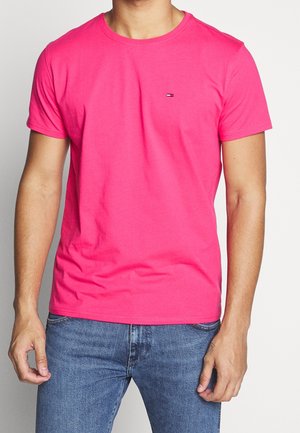 Bright pink short-sleeve t-shirt with a crew neck and subtle logo on the chest. Soft cotton fabric, casual fit, smooth texture.