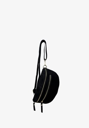 Black suede crossbody bag with a rounded shape, two gold zipper closures, and a long strap. Textured surface with tassel accents.