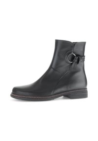 Schwarzlederne Knöchelbooties mit runder Zehenpartie, glatter Textur, seitlichem Schlaufen-Detail und niedrigem Blockabsatz. Solides Design mit dezenten Nähten.