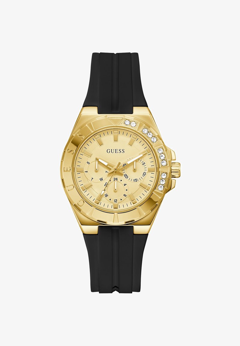 Montre Guess ton or avec bracelet en silicone noir, accents en cristal sur la lunette, trois sous-cadrans affichant le jour, la date et l'heure sur 24 heures.
