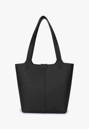 Must have must, etten must, millel on kaks õlavarre rihma, nupuga sulgemine ja minimalistlik, ilma dekoratsioonideta disain.