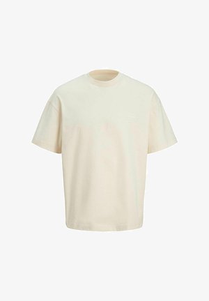 Kremowa koszulka z bawełny z krótkimi rękawami, okrągłym dekoltem i subtelnym graficznym wzorem na górnej lewej części klatki piersiowej.