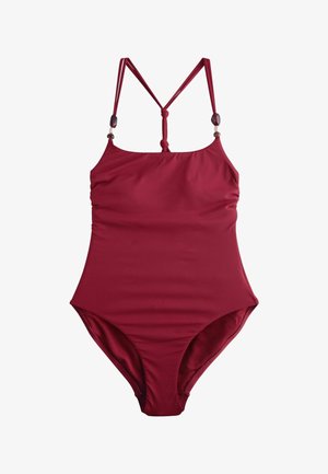 Raudonas vientisas maudymosi kostiumėlis su plonomis dvigubomis petnešėlėmis, reguliuojama nugaros juostele ir dekoratyviniais karoliukais ant petnešėlių, pagamintas iš lygaus audinio.