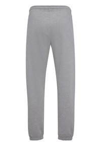 Grijze sweatpants van zachte stof, met een elastische tailleband, gesmoorde enkels en een gladde textuur zonder zakken of versieringen.