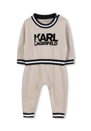 Combinaison en tricot beige avec des accents rayés noir et blanc, arborant le logo "KARL LAGERFELD" sur le devant et une fermeture à pression à l'épaule.