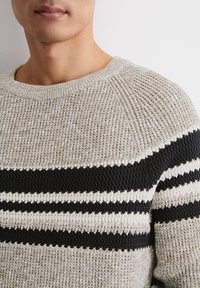 Chunky Strickpullover in Beige mit marineblauen und weißen Streifen. Mit einem gerippten Rundhalsausschnitt und strukturiertem Stoffmuster.