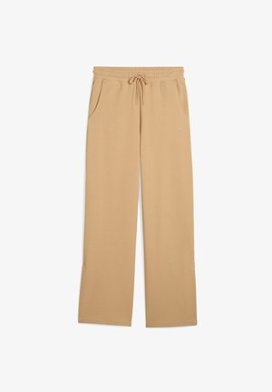 Pantaloni sportivi beige con vita elastica e cordoncino, dotati di due tasche laterali e un logo discreto sulla gamba. Il materiale ha una finitura testurizzata.