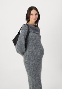 Abito in maglia grigia con scollo a barchetta e maniche lunghe, caratterizzato da una vestibilità ampia e un tessuto testurizzato, abbinato a una borsa nera.