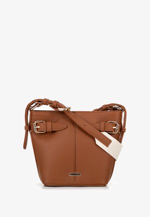 Brown leather handbag with a structured shape. Features adjustable straps with buckles and a textured finish. Includes a cream-colored accent.
