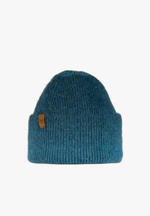 Knitted beanie in dark teal, featuring a ribbed texture, tapered top, and a brown label accent on the side.