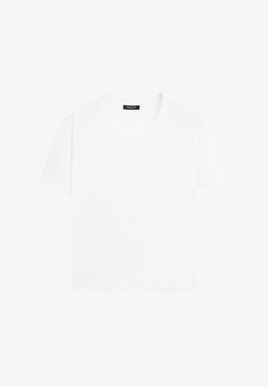 Vit kortärmad t-shirt i bomullstyg. Har rund halsringning och en avslappnad passform. Slät yta, inga mönster eller detaljer.