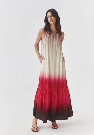 Maxi dress in a gradient ombre pattern, transitioning from beige to red, with a tiered hem and pockets. Smooth fabric, sleeveless design.