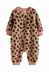Tuta intera con stampa leopardata in morbido tessuto peloso. Presenta macchie nere su uno sfondo beige, con maniche lunghe e polsini a costine. Chiusura frontale con zip.