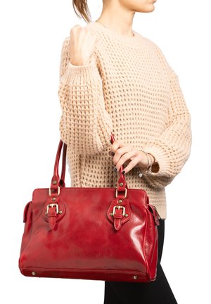 Red leather handbag with shiny finish, dual handles, prominent hardware accents, rectangular shape, and stitched detailing.