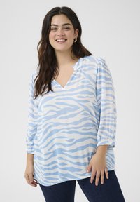 Lightweight blue and white zebra-striped blouse with a V-neck, gathered detailing at the shoulders, and three-quarter sleeves.