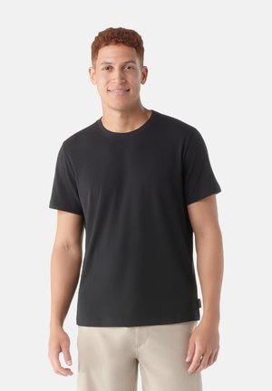 Zwarte korte mouwen t-shirt in een ontspannen pasvorm, gemaakt van zacht katoen, met een klassiek ronde halsontwerp en een soepele textuur.