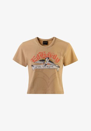 Beige short-sleeve crop t-shirt featuring a graphic print with wings and the text "Ed Hardy LIVE TO RIDE" in red and black accents.