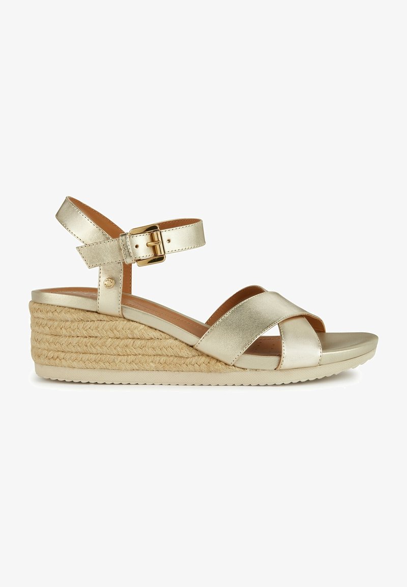 Metallic gold wedge sandal with cross-strap design, ankle buckle, and woven rope texture on heel. Smooth surface with a flat sole.