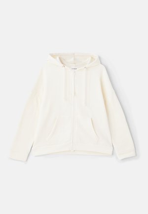 Krém színű zipzáros kapucnis pulóver, zsinóros kapucnival, elülső zsebekkel, széles ujjaival és bordás mandzsettáival. Puha, textúrált anyagból készült.